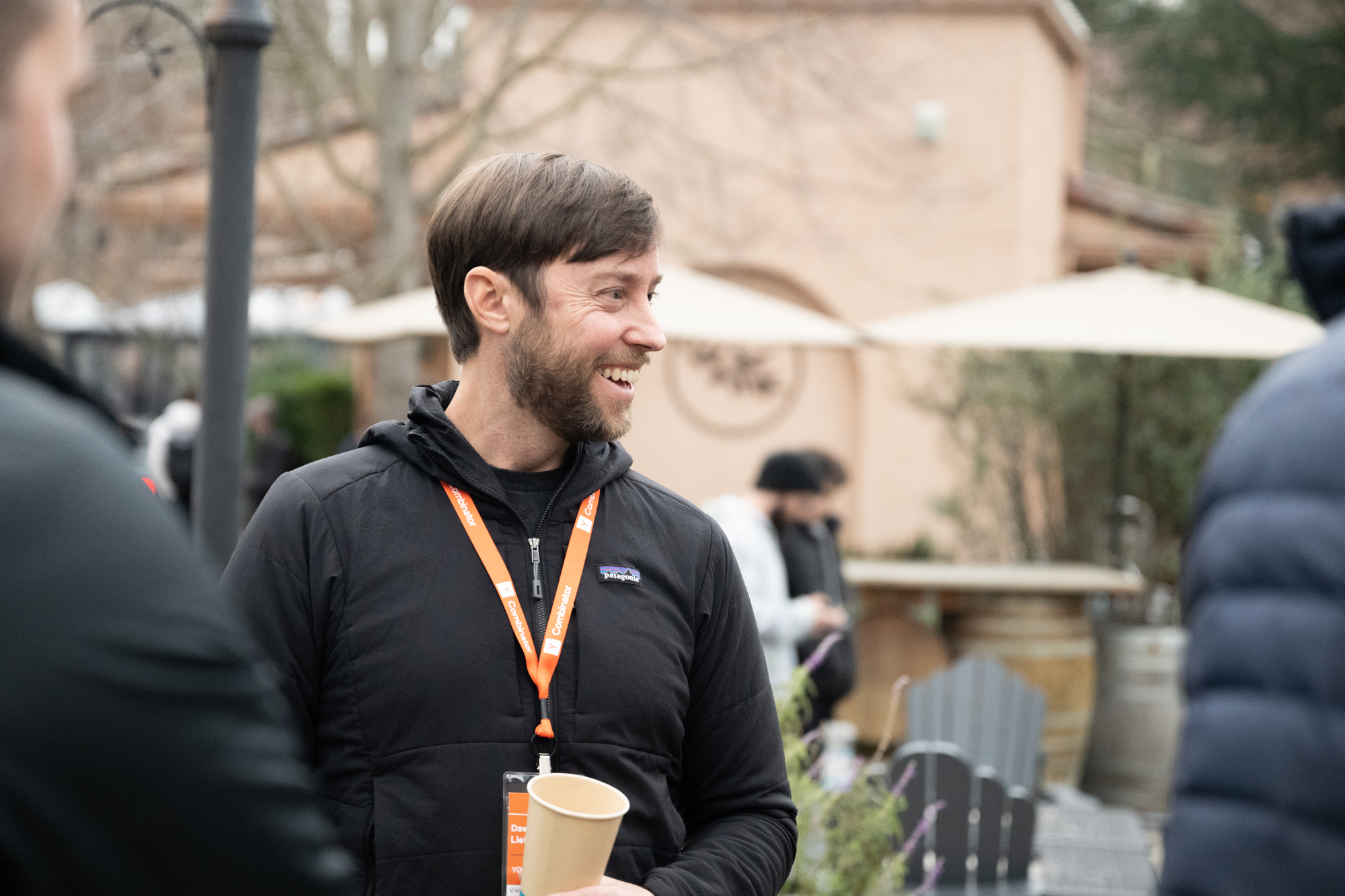A photo of David Lieb wearing a black jacket and an orange lanyard
